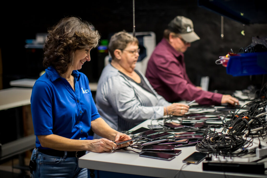 employees looking at multiple devices